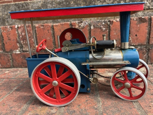 Model traction engine against brick background